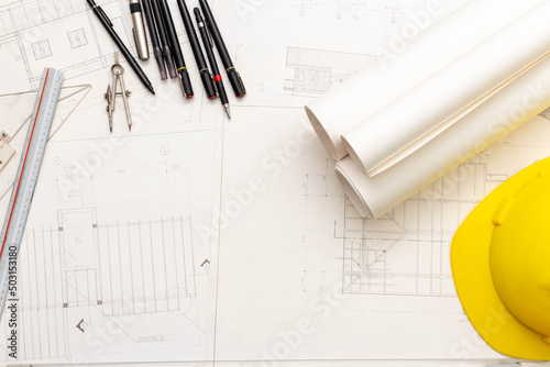 Mockup of architectural concept, Drawing tools and engineer drawing on blueprint with safety helmet
