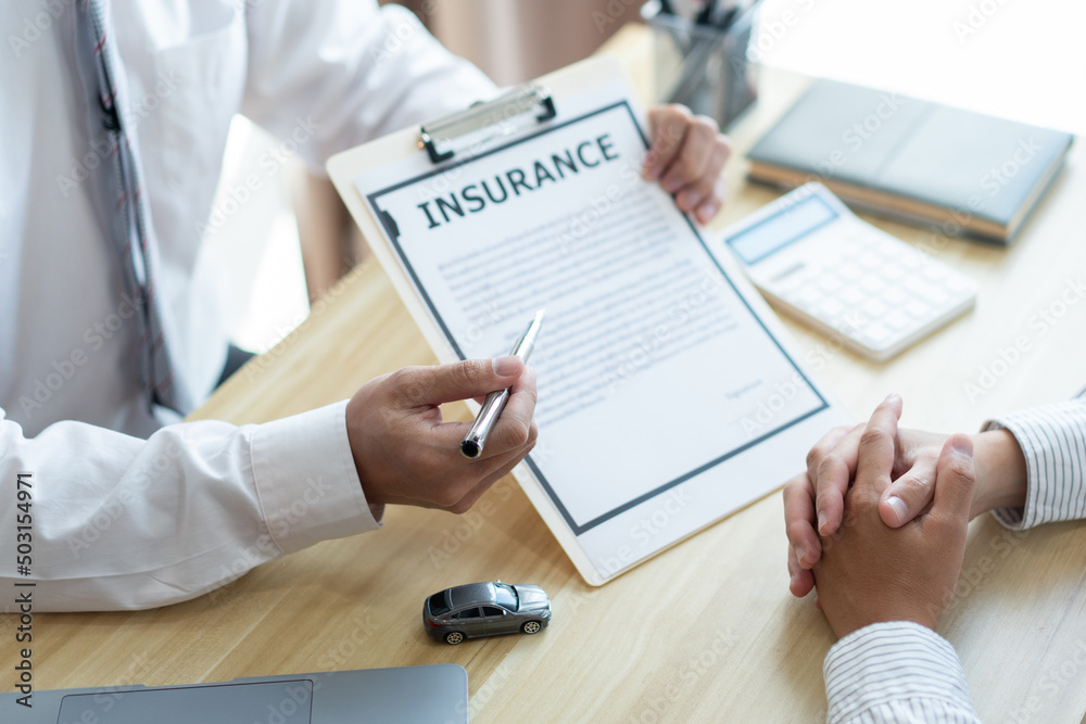 Insurance concept the auto dealer emphasizing on the agreement of the contract for his client Insurance concept the auto dealer emphasizing on the agreement of the contract for his client
