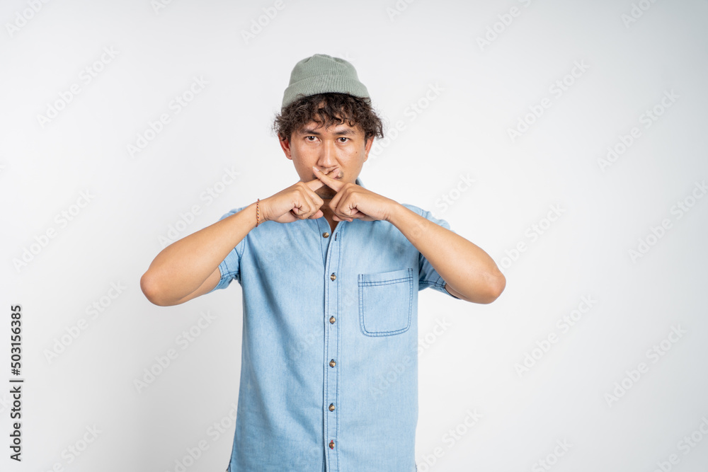portrait of a man with hands covering mouth standing over isolated background. stop talking concept portrait of a man with hands covering mouth standing over isolated background. stop talking concept