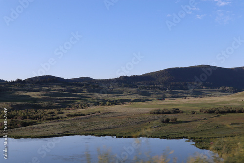 View of scnenic red rock landscape in National Park in Utah, USA with a lake or a pond in the middle photo