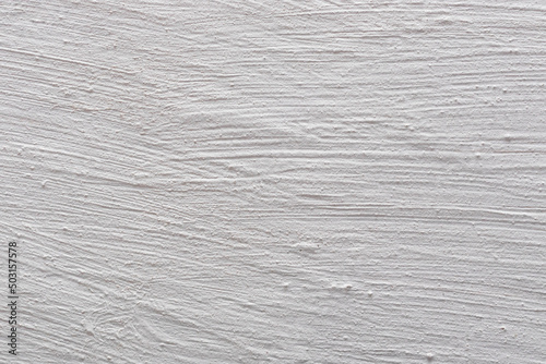 The background is in the form of a fragment of a plastered and whitewashed chalk wall. Texture of whitewashed plaster.