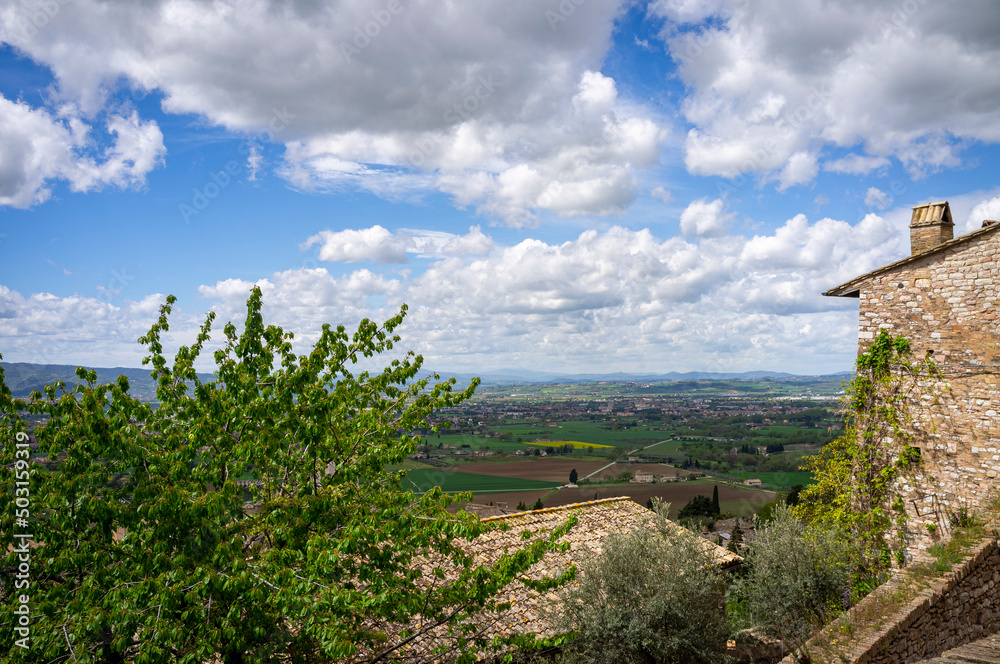 Panoramic wide view of the countryside surrounding the medieval village of Assisi, in springtime (Umbria, central Italy). It's world famous as the city of St. Francis.