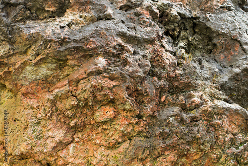 Cliff surface with mossy stone and rock formation. Beautiful rough and uneven texture