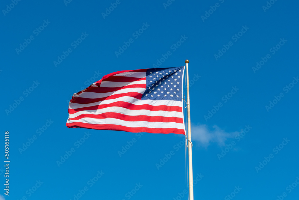American flag in front of blue sky American flag in front of blue sky