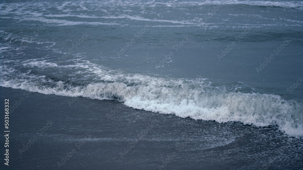 Blue water waves crashing coast background. Ocean foam splash in sea landscape. Blue water waves crashing coast background. Ocean foam splash in sea landscape.