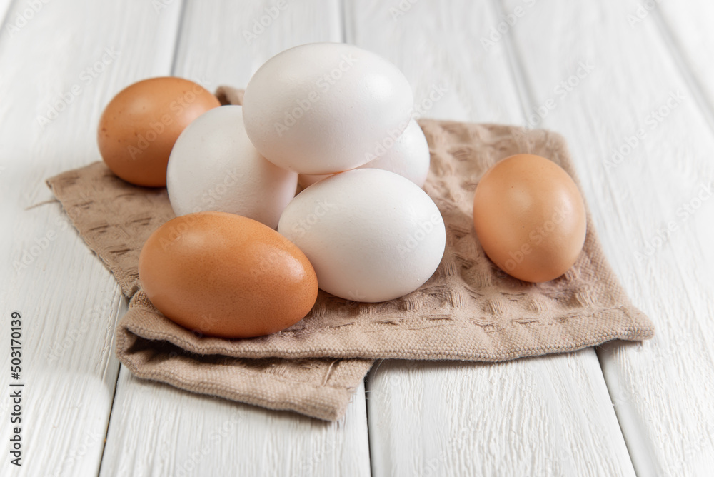 Several eggs on a towel on a white background Several eggs on a towel on a white background
