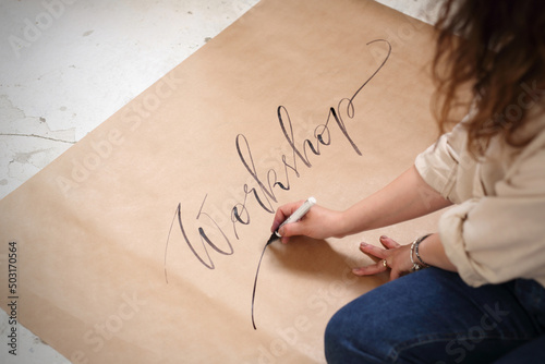 Calligraphy, a workshop of beautiful writing. Calligraphy, woman writes with a fountain pen.