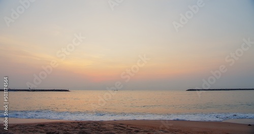 scenic Dramatic Ocean tropical sea beach sunrise dramatic colorful sky clouds and waves in the morning in Thailand with fishing boat on background   © HarryKiiM Stock