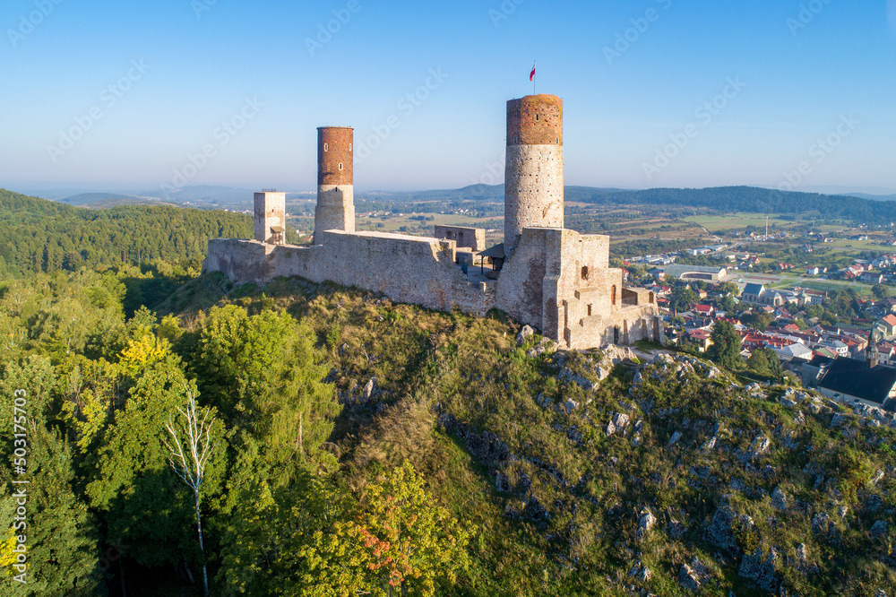 Medieval royal castle in Checiny near Kielce in Poland. Built in late 13th century. Ruin partly renovated. Aerial view in sunrise light.