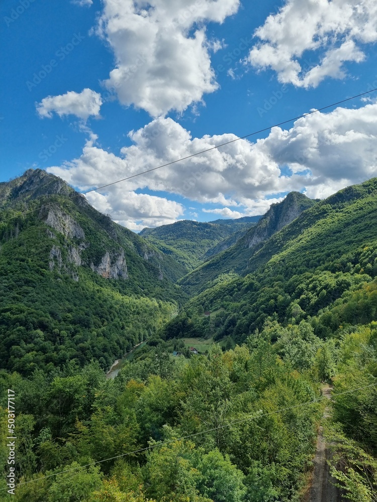 Picturesque canyon of the Tara river.Mountains surrounding the canyon.Forests on the slopes of the mountains.Haze over the mountains.  View from the Djurdzhevich Bridge Montenegro