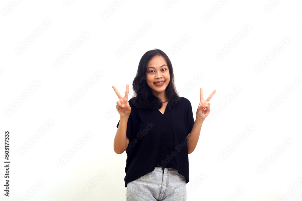 Happy beautiful young woman showing peace sign with both hands over white background Happy beautiful young woman showing peace sign with both hands over white background