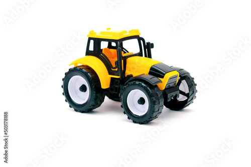 Colorful little mini yellow plastic tractor, truck, lorry, car toy isolated on white background mockup with copy space, toys for children, kids development, playing, childhood fun