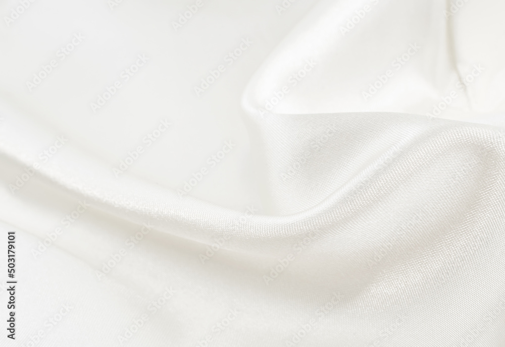 Obraz premium Background from white wrinkled fabric. White satin with folds and waves