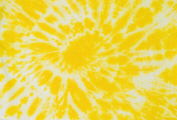 Beautiful white and yellow tie dye pattern on the fabric. Flat lay.