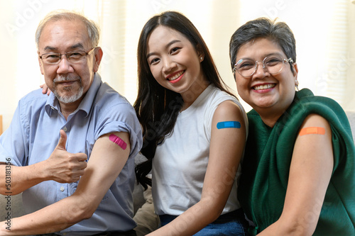 Group of diverse age Asian people family senior showing bandage plaster on arm after received covid vaccination for prevent covid-19 infection. Coronavirus pandemic protection health care concept.