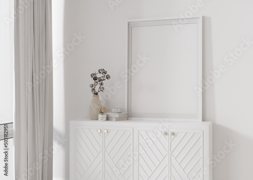 Empty vertical picture frame standing on white sideboard in modern living room. Mock up interior in contemporary style. Free, copy space for picture. Console, cotton plant. Close up. 3D rendering.