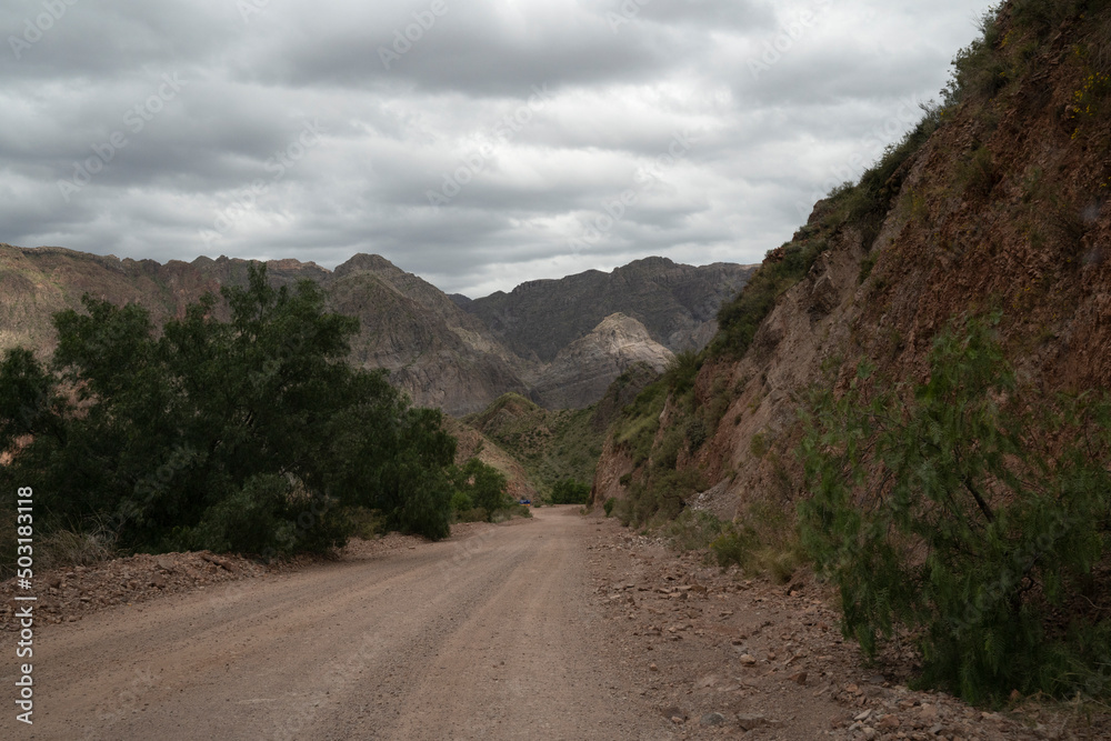 Travel. View of the dirt road across the desert and mountains.