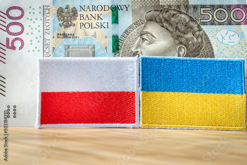 500+ Five hundred zloty banknote, plus sign and the flag of Ukraine and Poland, Concept of the Polish social program supporting parents, Extented fo Ukrainian mothers fleeing the war photo