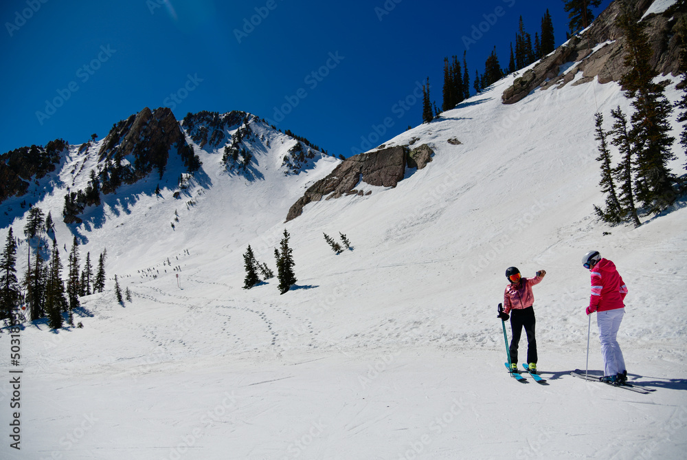 Female skiers enjoy beautiful landscape at Snowbasin Ski Resort in Utah.