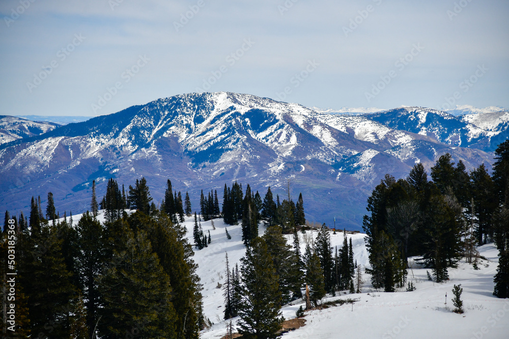 Beautiful landscape at Snowbasin Ski Resort, Utah. Range of mountains with peaks covered with snow.