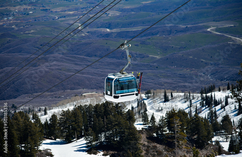 Gondola lift going up at the Snowbasin Ski Resort in Utah. Breathtaking view to the valley.