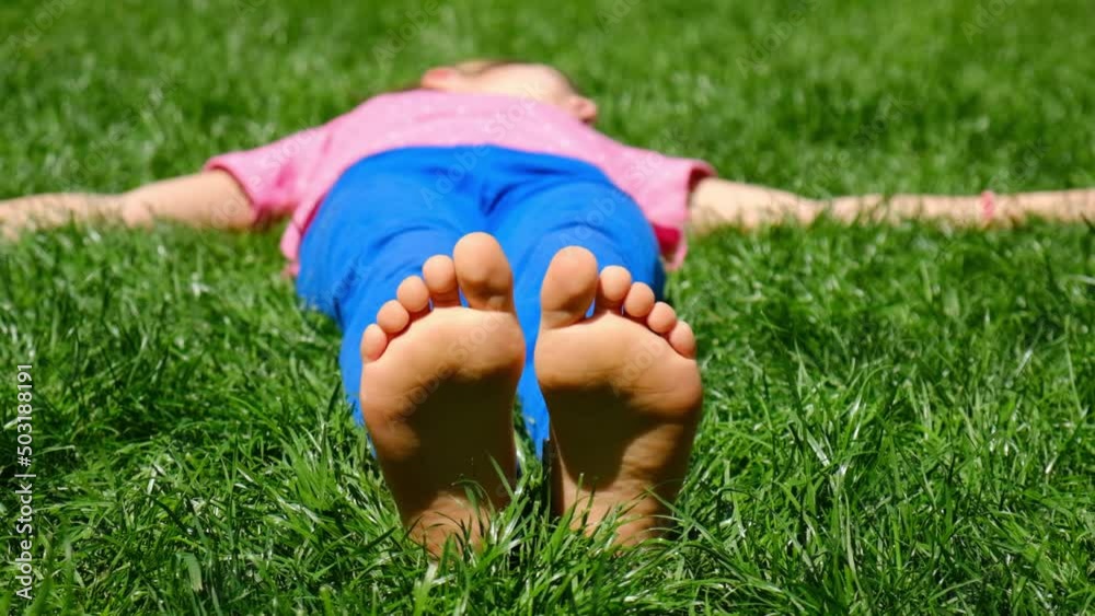 Child feet on the grass. Selective focus. Kid. Child feet on the grass. Selective focus. Kid.