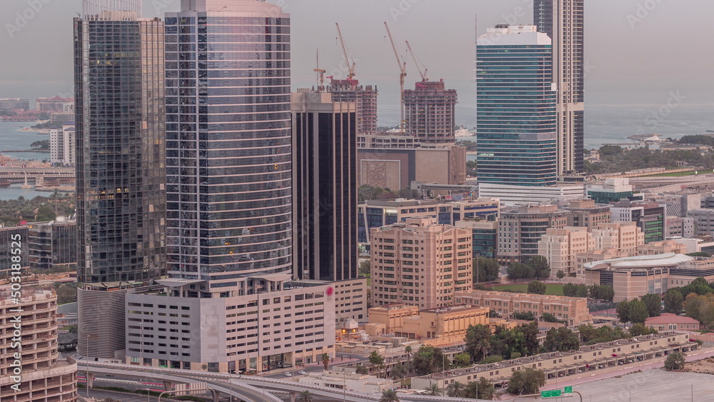 Fototapeta premium Office buildings in Dubai Internet City and Media City district aerial night to day timelapse