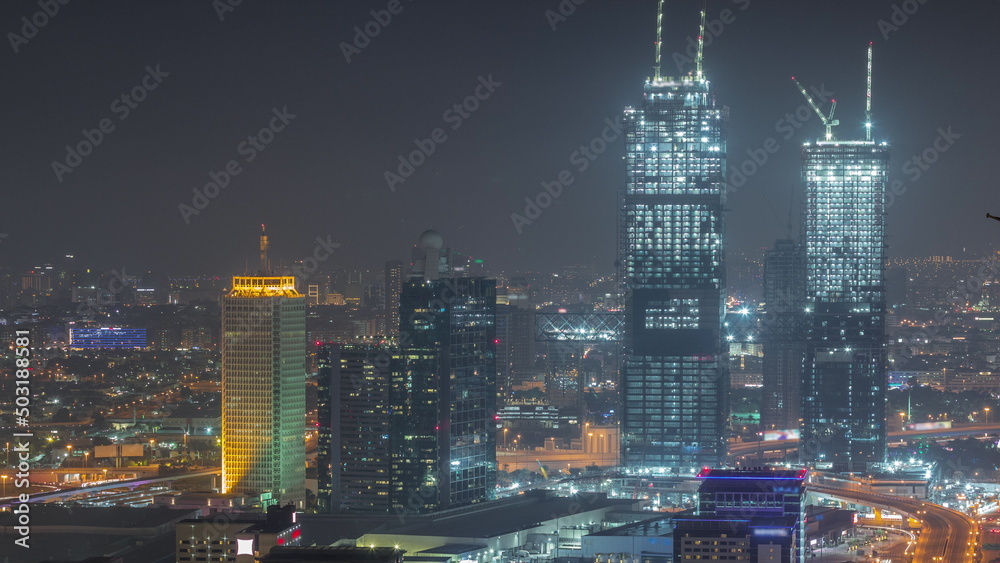 Aerial view of skyscrapers with World Trade center in Dubai night timelapse.