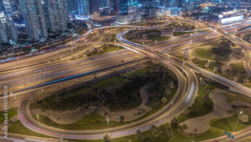 Aerial view on Dubai Marina with big highway intersection night timelapse and skyscrapers around, UAE © neiezhmakov