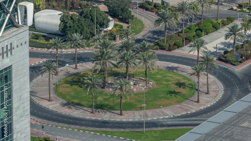Aerial view of a roundabout circle road in Dubai financial district from above timelapse.