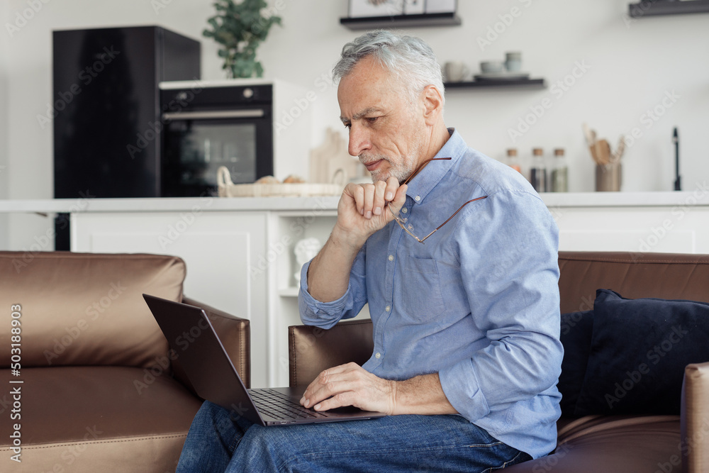Fototapeta premium Senior man making video call on laptop computer