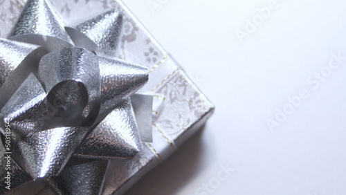 silver gift box and silver ribbon on white background