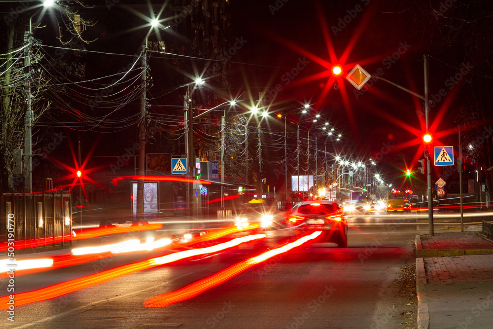 Long exposure of cars headlights and traffic light at night city