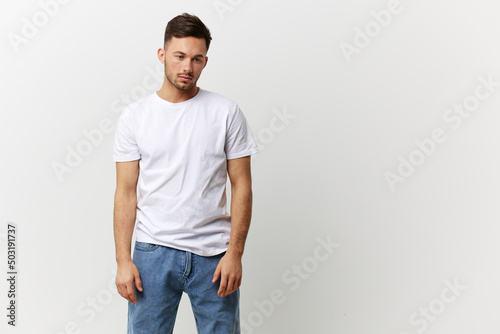 Tired frustrated tanned handsome man in basic t-shirt think about problems at work posing isolated on over white studio background. Copy space Banner Mockup. People emotions Lifestyle concept