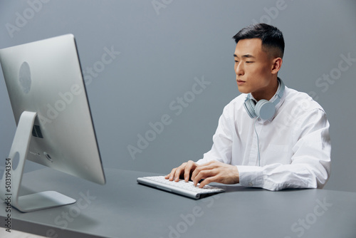 businessmen in a white shirt with headphones sits in the office Lifestyle work