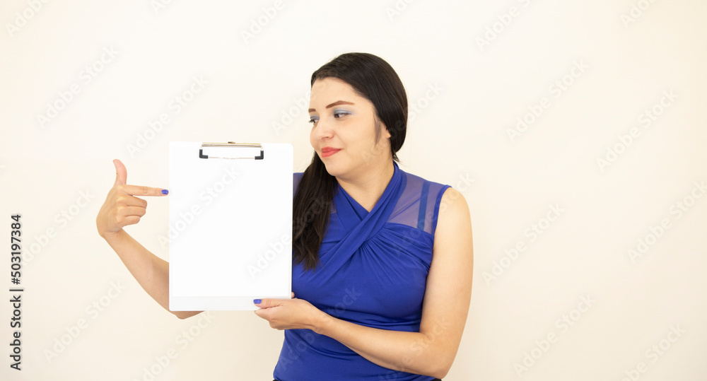 Beautiful and successful CEO assistant, wearing blue blouse, satisfied, pointing with his hand information on a clipboard, on white background. Beautiful and successful CEO assistant, wearing blue blouse, satisfied, pointing with his hand information on a clipboard, on white background.