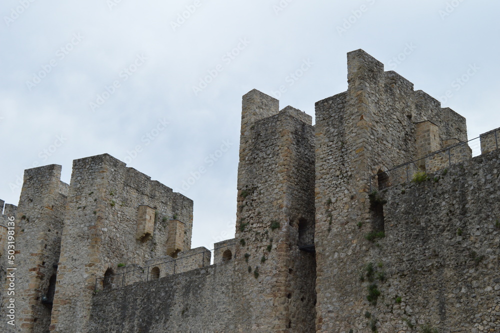 Stone walls and towers of a medieval castle from the 15th century
