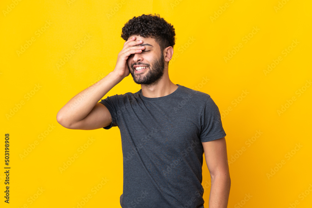 Young Moroccan man isolated on yellow background smiling a lot Young Moroccan man isolated on yellow background smiling a lot
