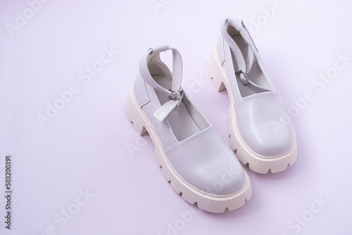 Women's shoes with massive soles. Mary Jane shoes. Beige shoes with modern thick soles. Modern fashion trend. View from above