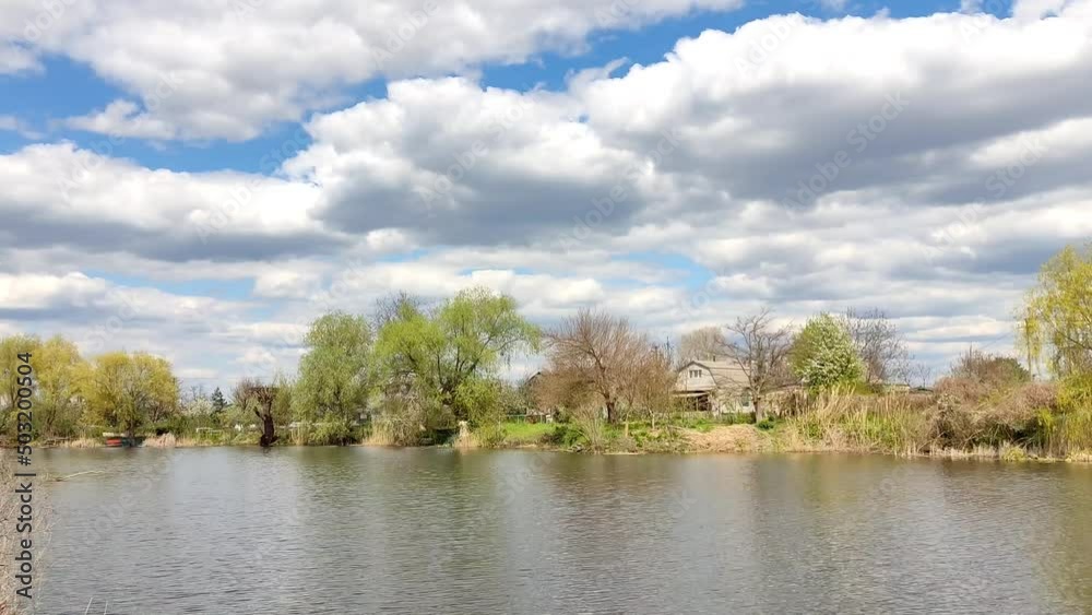 Picturesque landscape near the water with white clouds in the sky, went fishing Picturesque landscape near the water with white clouds in the sky, went fishing