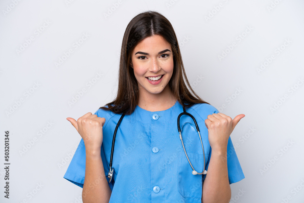 Young Brazilian nurse woman isolated on white background with thumbs up gesture and smiling Young Brazilian nurse woman isolated on white background with thumbs up gesture and smiling