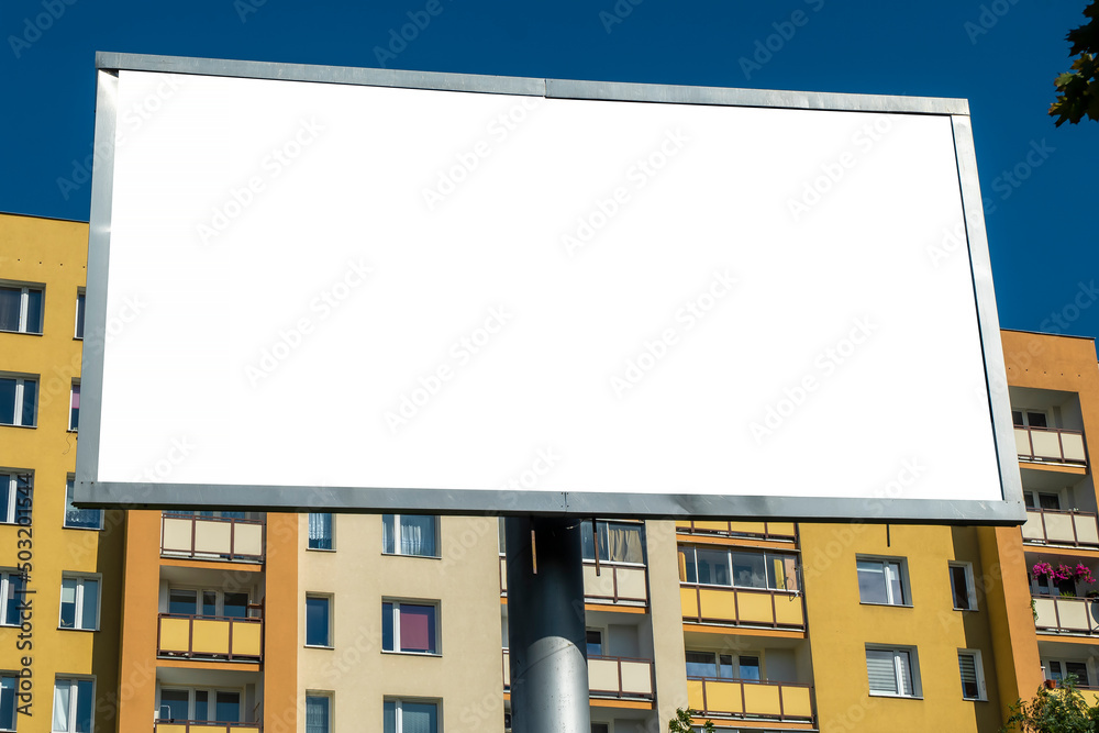 Blank white advertising billboard near residential buildings in the city on a sunny summer day. Blank white advertising billboard near residential buildings in the city on a sunny summer day.