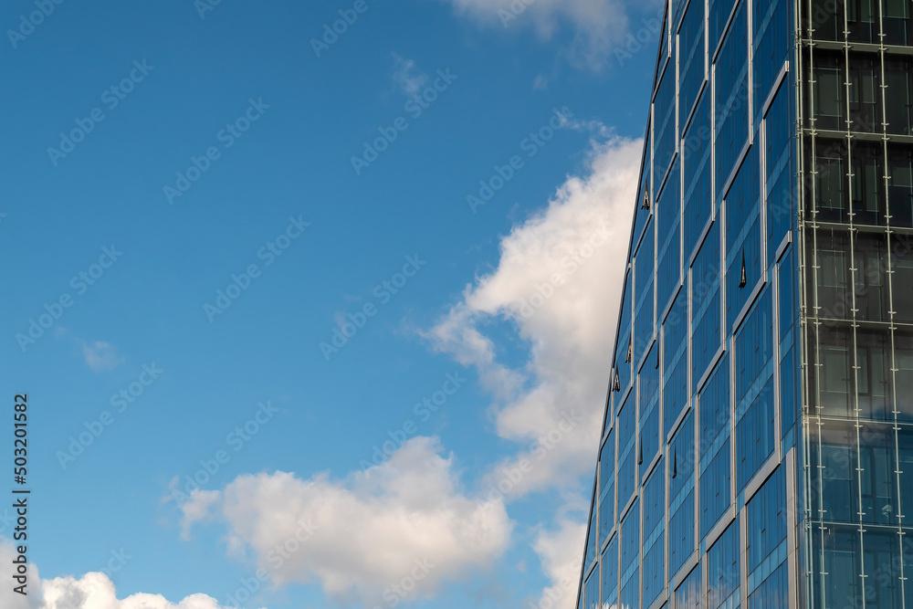 Modern office building with glass facade in downtown. Sunny sumer day Modern office building with glass facade in downtown. Sunny sumer day