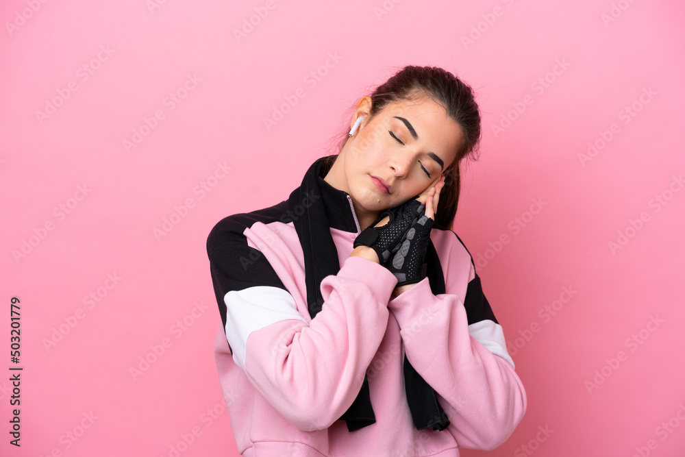 Young sport Brazilian woman isolated on pink background making sleep gesture in dorable expression
