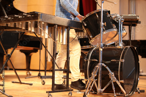 Drum set close-up and musician playing percussion