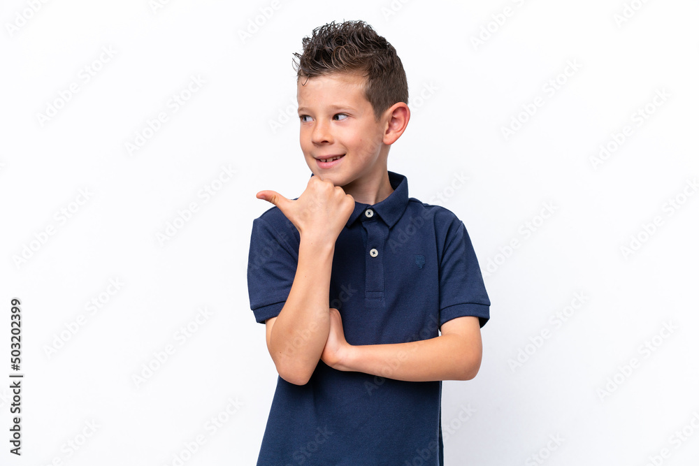 Little caucasian boy isolated on white background pointing to the side to present a product Little caucasian boy isolated on white background pointing to the side to present a product