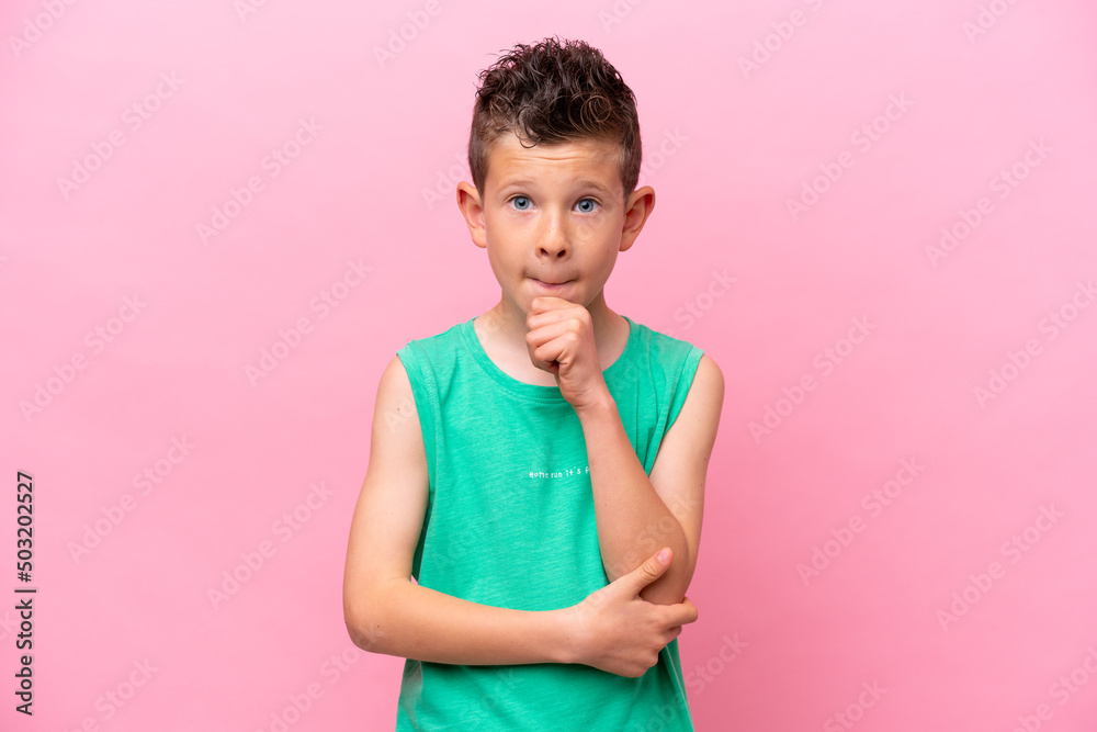 Little caucasian boy isolated on pink background having doubts and thinking Little caucasian boy isolated on pink background having doubts and thinking