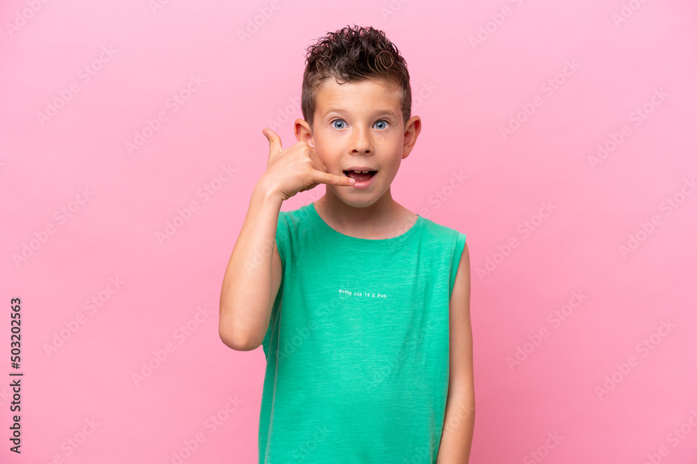 Little caucasian boy isolated on pink background making phone gesture. Call me back sign Little caucasian boy isolated on pink background making phone gesture. Call me back sign