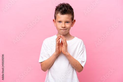 Canvas Print Little caucasian boy isolated on pink background scheming something