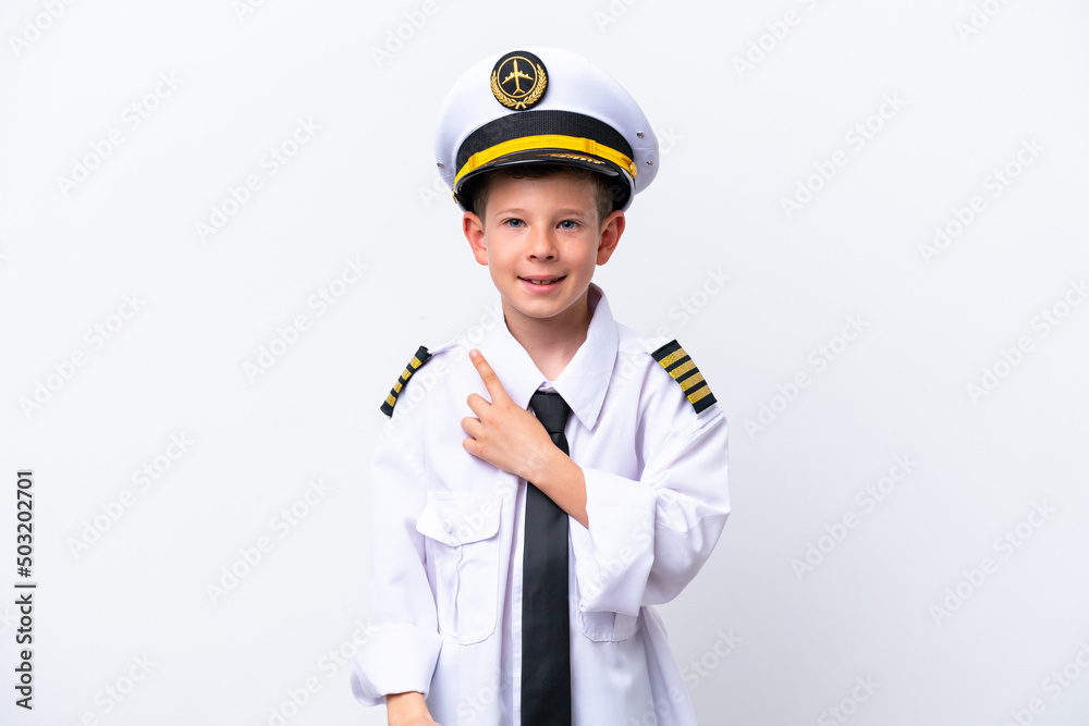 Little airplane pilot boy isolated on white background pointing to the side to present a product Little airplane pilot boy isolated on white background pointing to the side to present a product